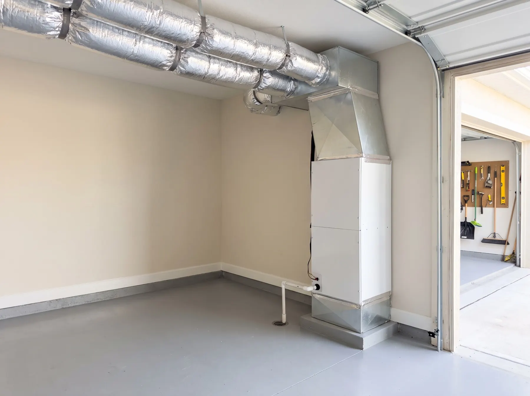 New vertical air handler installed in a clean Florida garage with neatly strapped flex duct