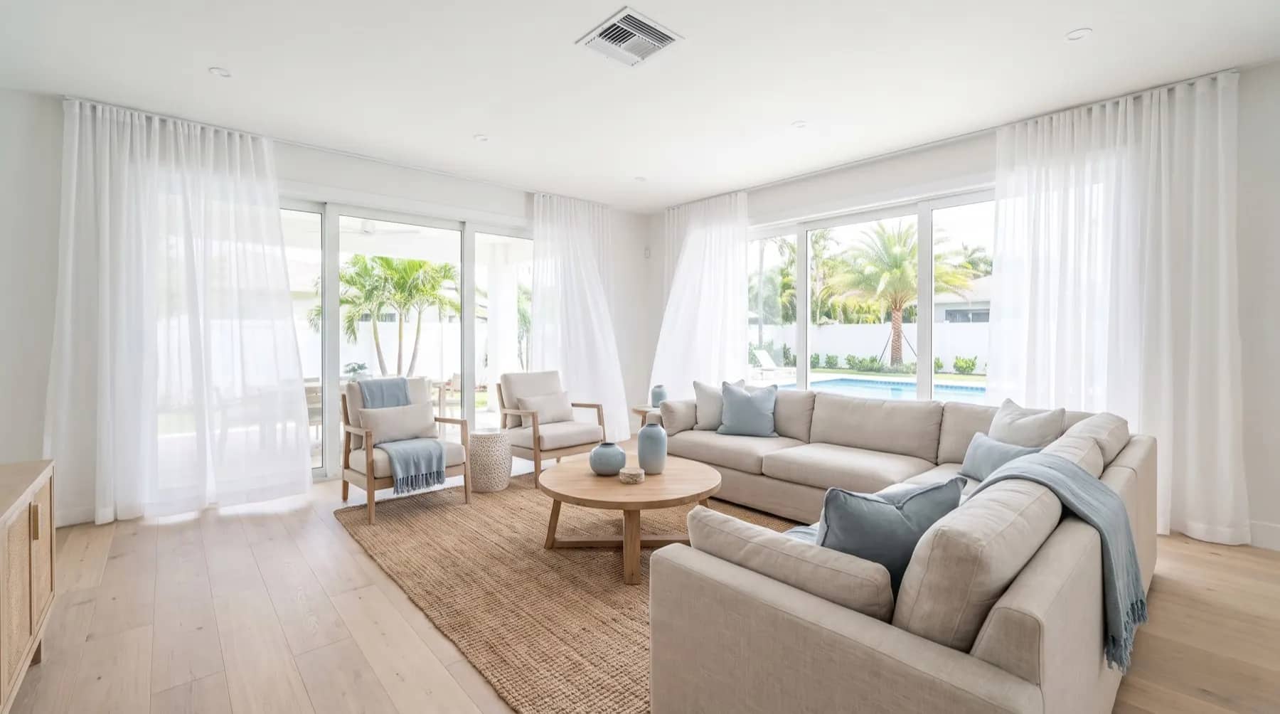 Cool, bright Florida living room with sliding glass doors and a ceiling supply vent