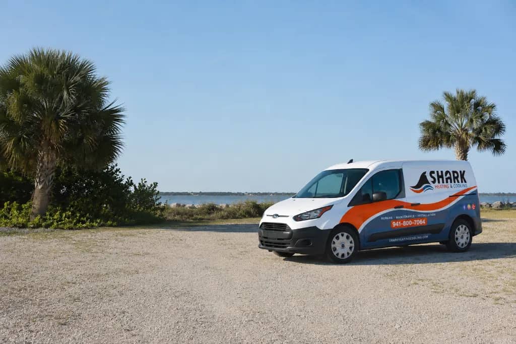 Shark Heating and Cooling service van parked beside the Southwest Florida waterfront
