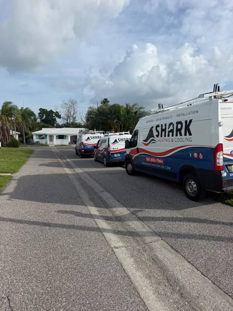 Shark Heating and Cooling service vans lined up outside