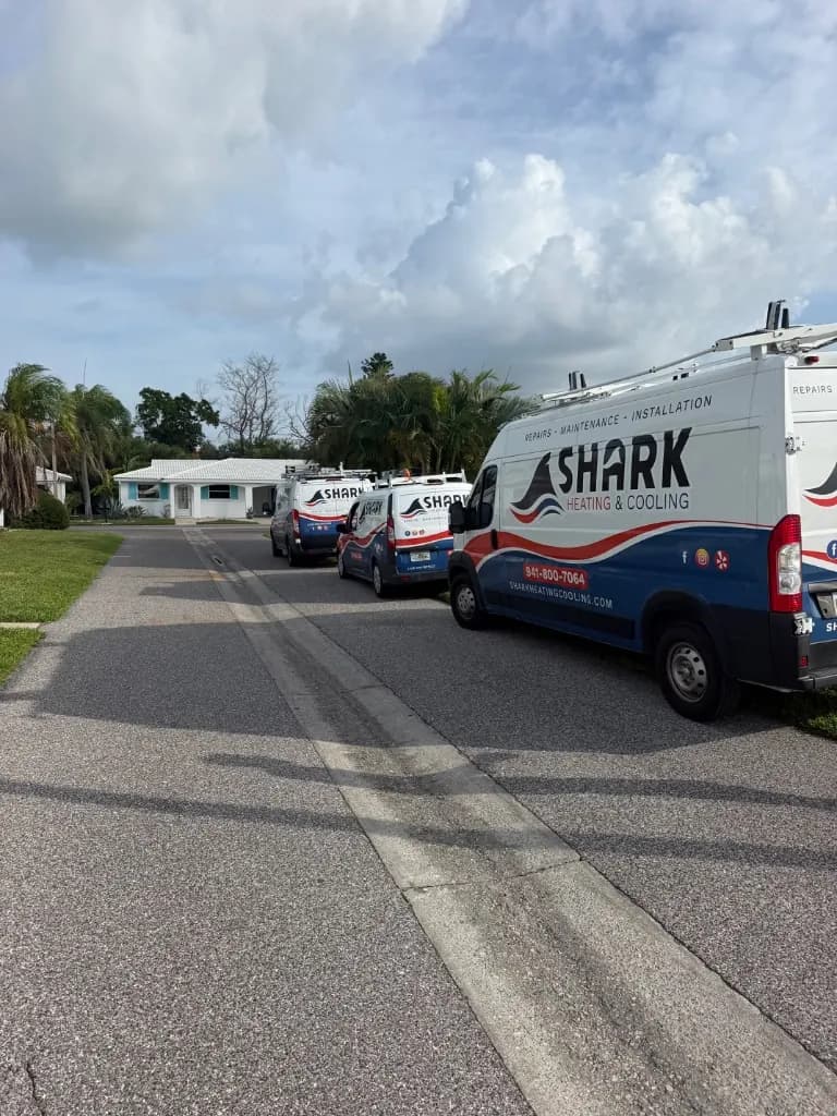 Shark Heating and Cooling service vans lined up outside